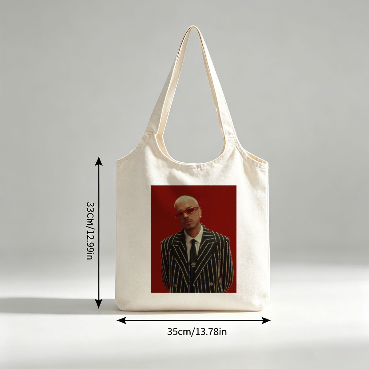 J Balvin in a Striking Red-Background Portrait Wearing a Glittering Black Suit and Red Sunglasses - Canvas shoulder bags/