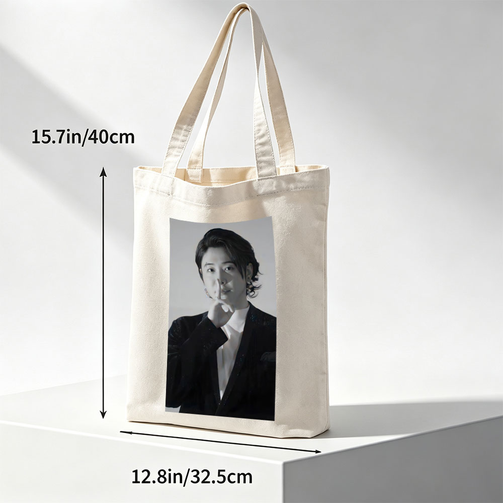 Kai from EXO in a dramatic pose with finger on lips, wearing a sparkling black suit and white shirt, set against a neutral background. - Canvas tote bags