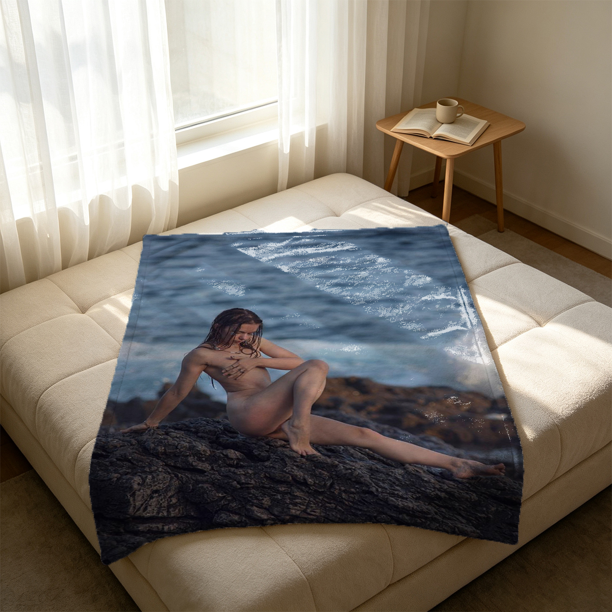A woman in black lace lingerie lying on a patterned bed. - Blanket