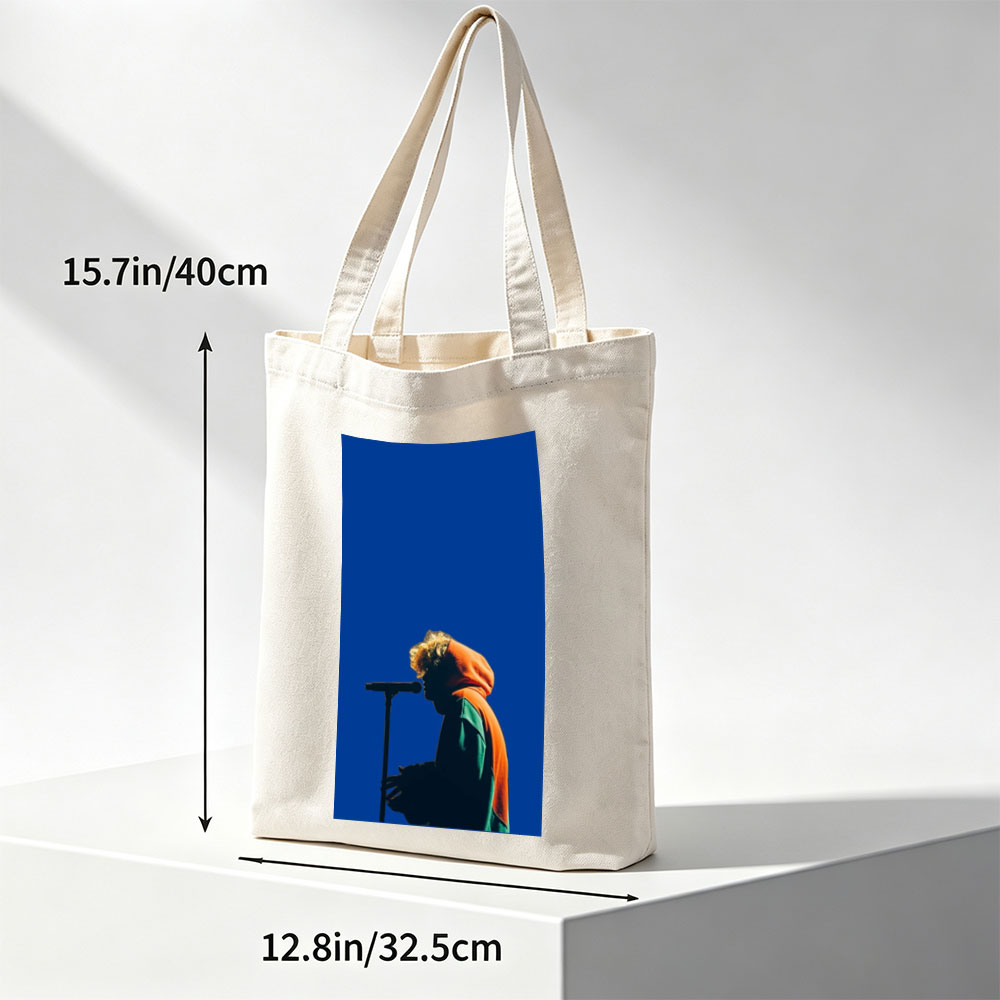 Troye Sivan Performing on Stage with Microphone Against Blue Background - Canvas tote bags