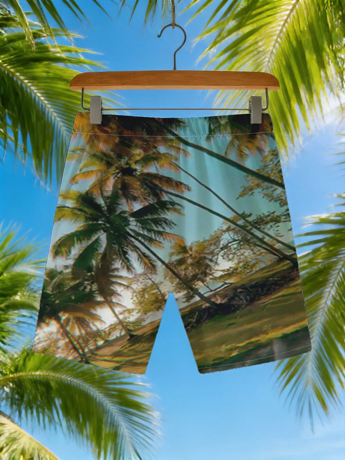 Tropical palm trees sway under a clear blue sky, casting golden shadows on the ground. -  Beach shorts