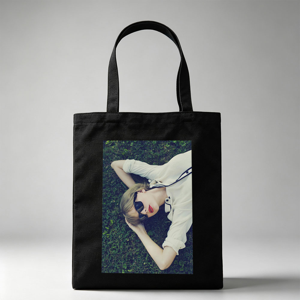 Taylor Swift Lying on Grass Wearing Sunglasses and Red Lipstick - Canvas tote bags