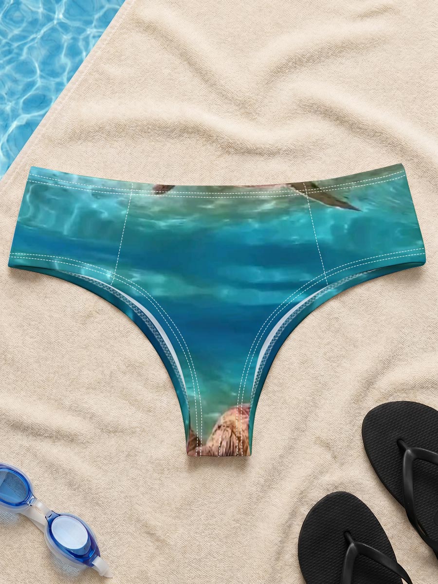 Sea turtles swim gracefully in clear blue waters, one near the surface and one gliding over sandy ocean floor. -  Men's swim trunks