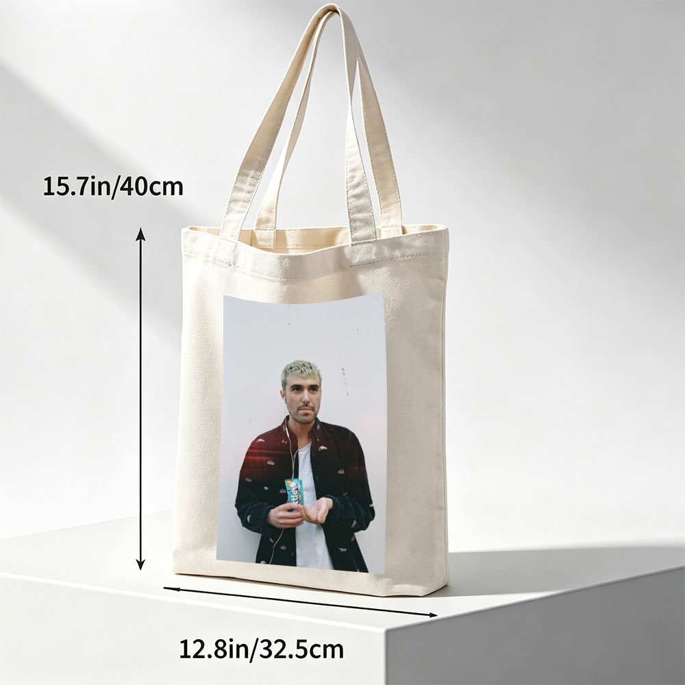 Lauv Standing Against White Wall Holding Candy Bar with Earphones - Canvas tote bags