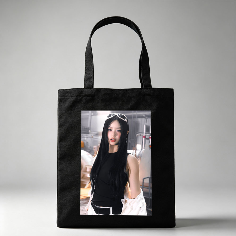 Hanni of NewJeans in a Futuristic Studio Setting Wearing a Black Top and White Ruffled Skirt with Sunglasses on Head - Canvas tote bags