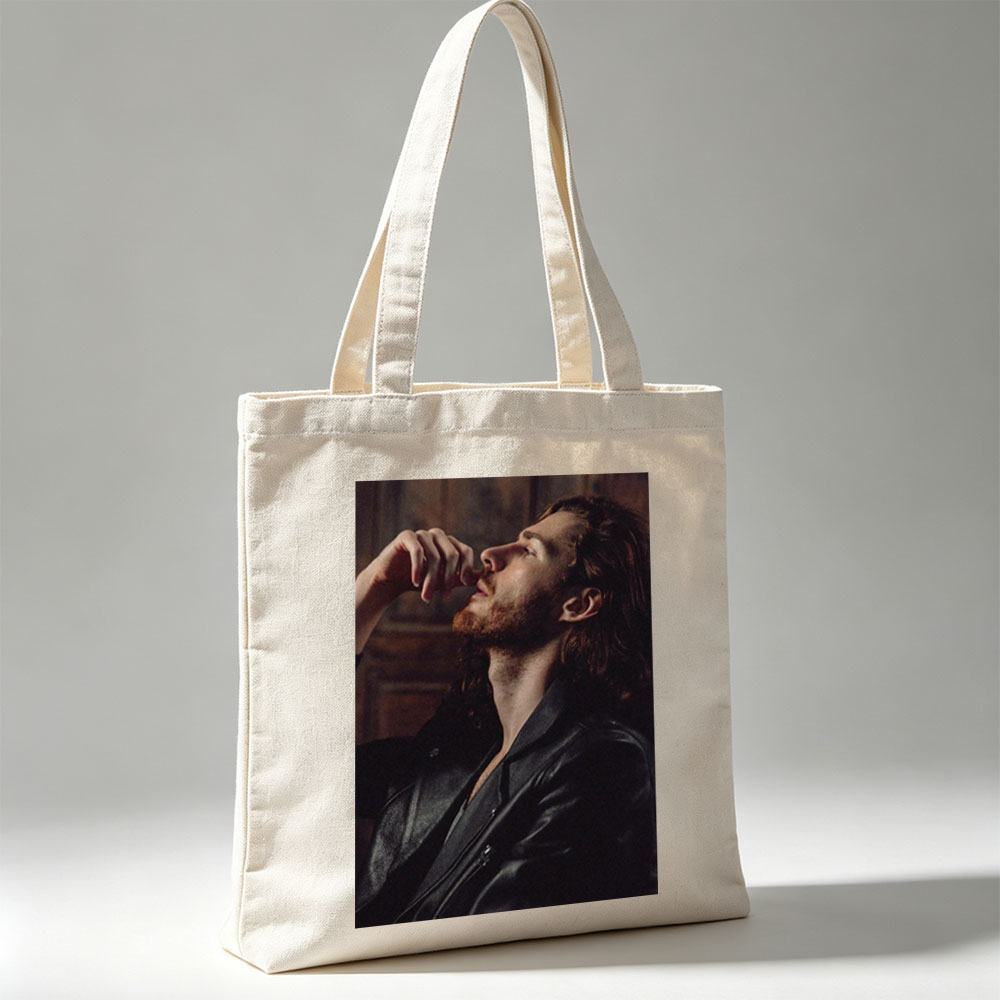Hozier in a Moody Portrait Wearing a Leather Jacket and Gazing Upward - Canvas tote bags