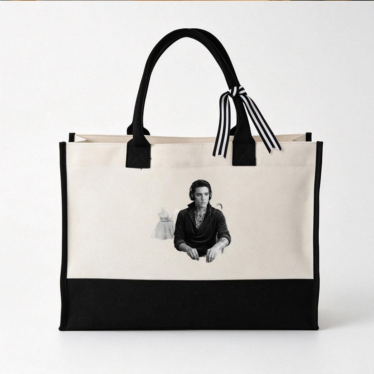 Elvis Presley as a DJ with tattoos, wearing headphones, in a black suit, with a woman in a vintage dress in the background. - Canvas patchwork gift tote bag