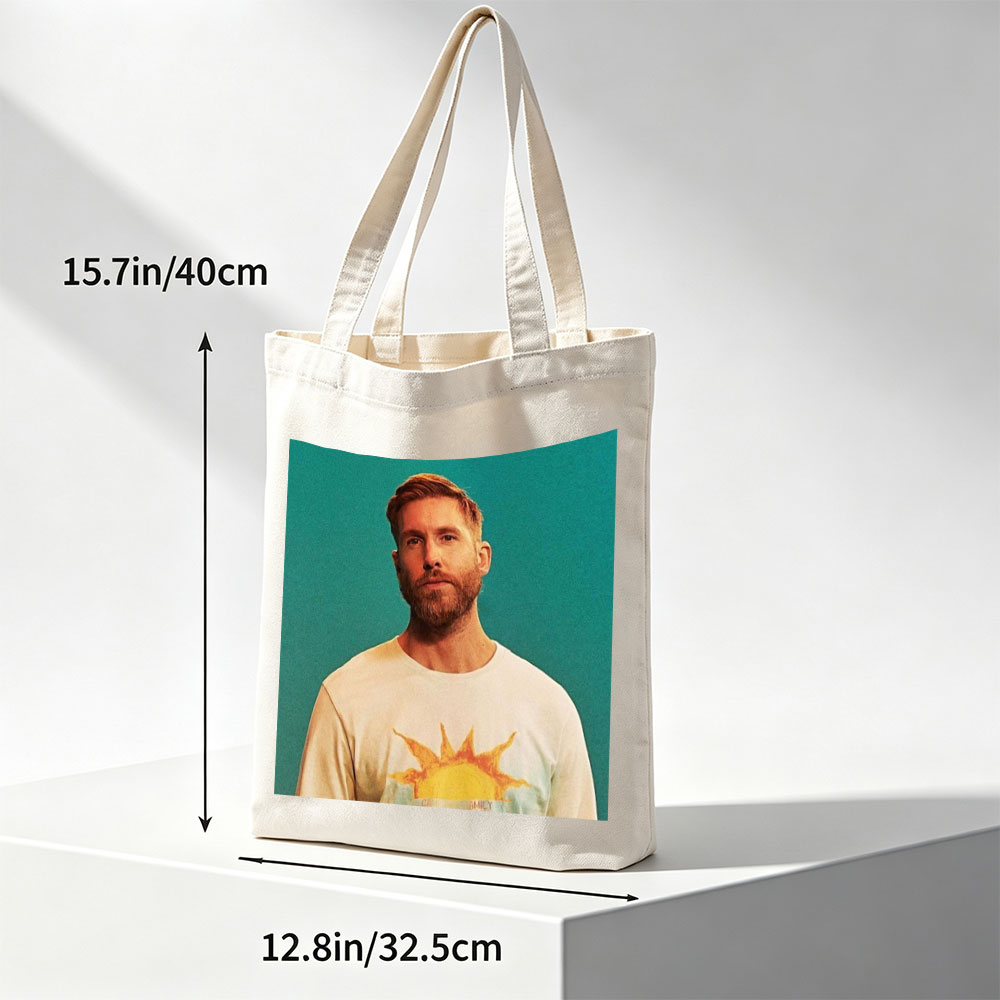 Calvin Harris in a Sun-Themed T-Shirt Against a Teal Background - Canvas tote bags