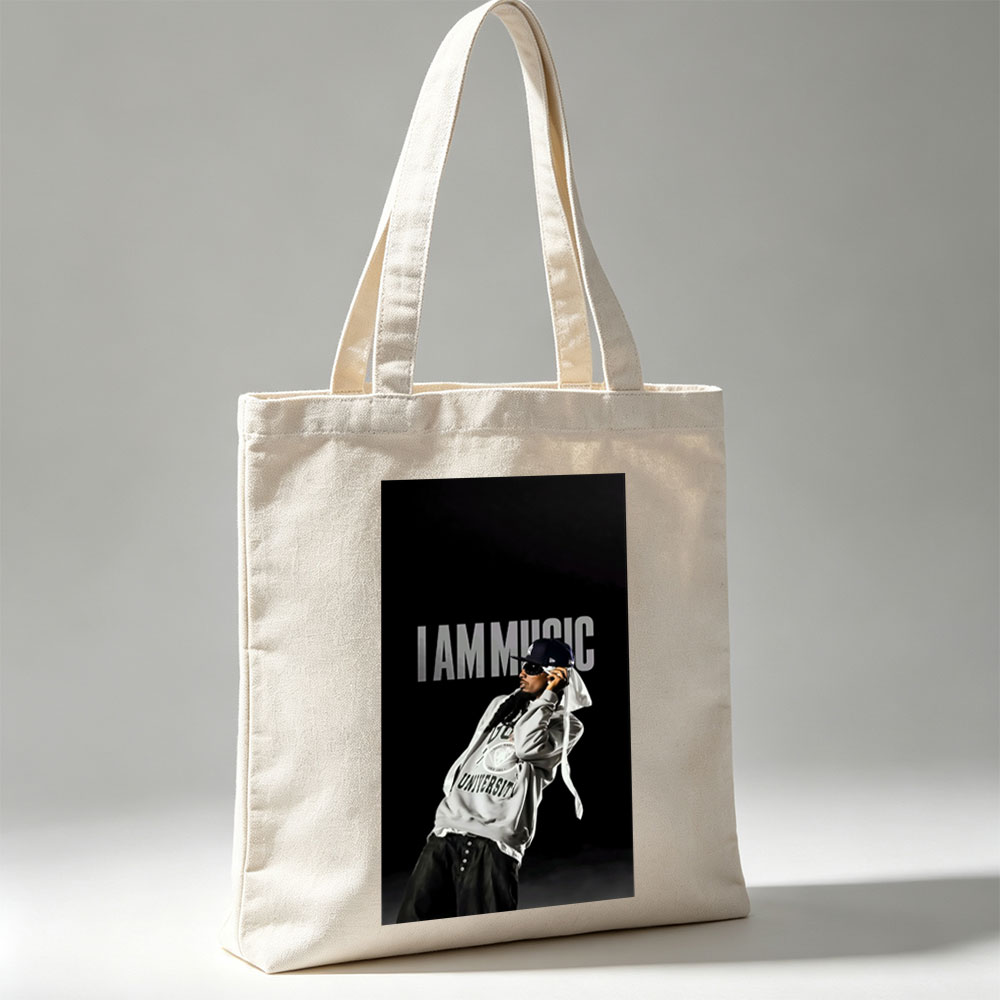 IamMusic Artist in Stylish Pose Wearing Hoodie and Cap Against Dark Background - Canvas tote bags