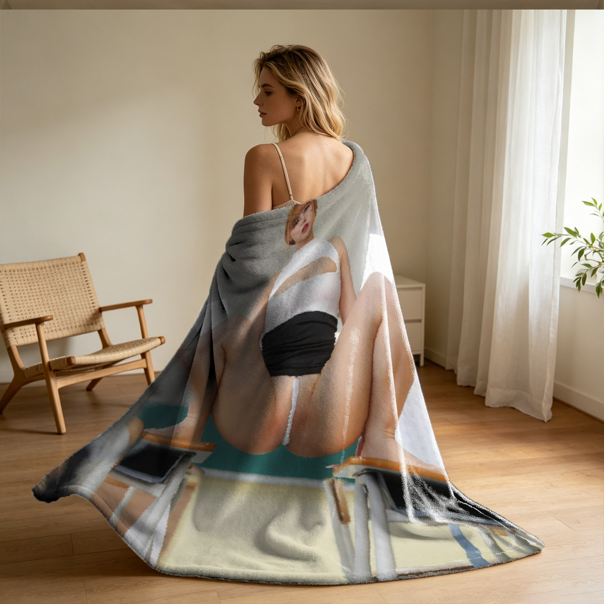 Nude blonde woman lying on black couch with blue sheet - Blanket