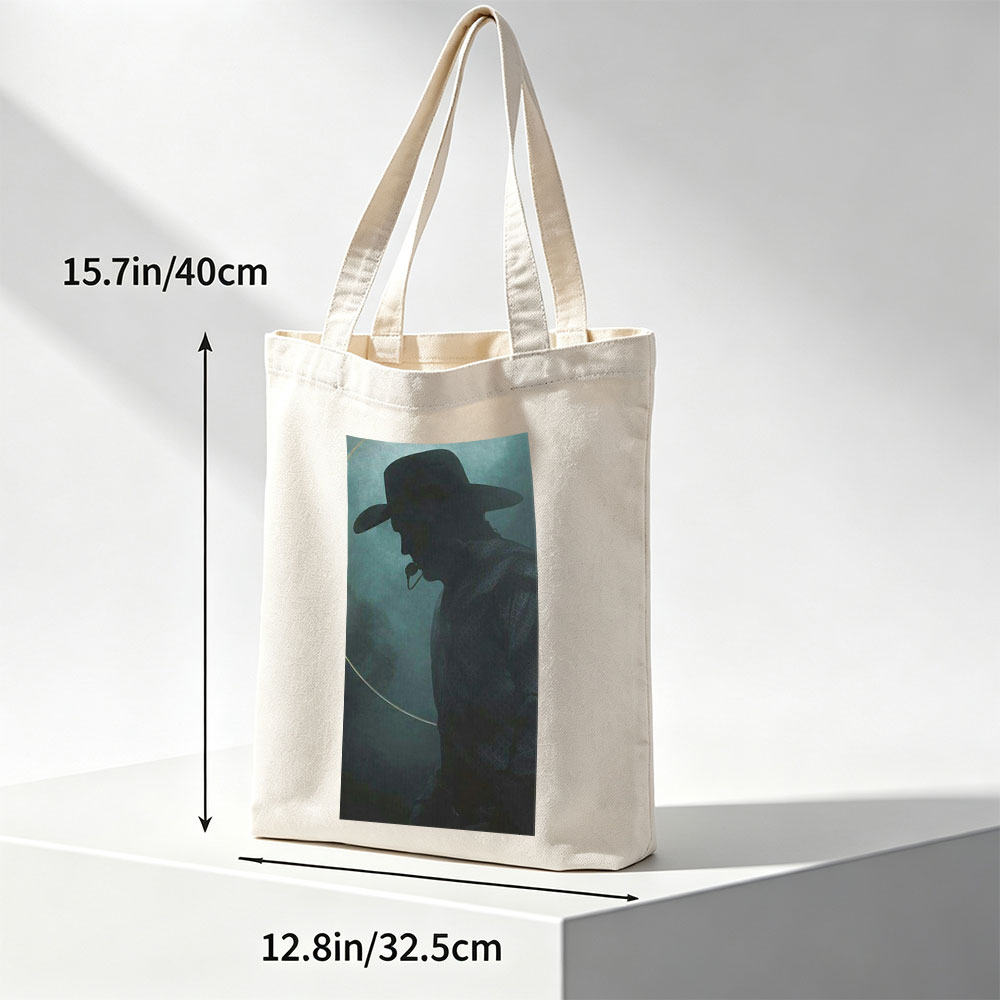 Johnny Cash in the Mist – Silhouette of a Cowboy with Hat and Pipe Against a Foggy Background - Canvas tote bags