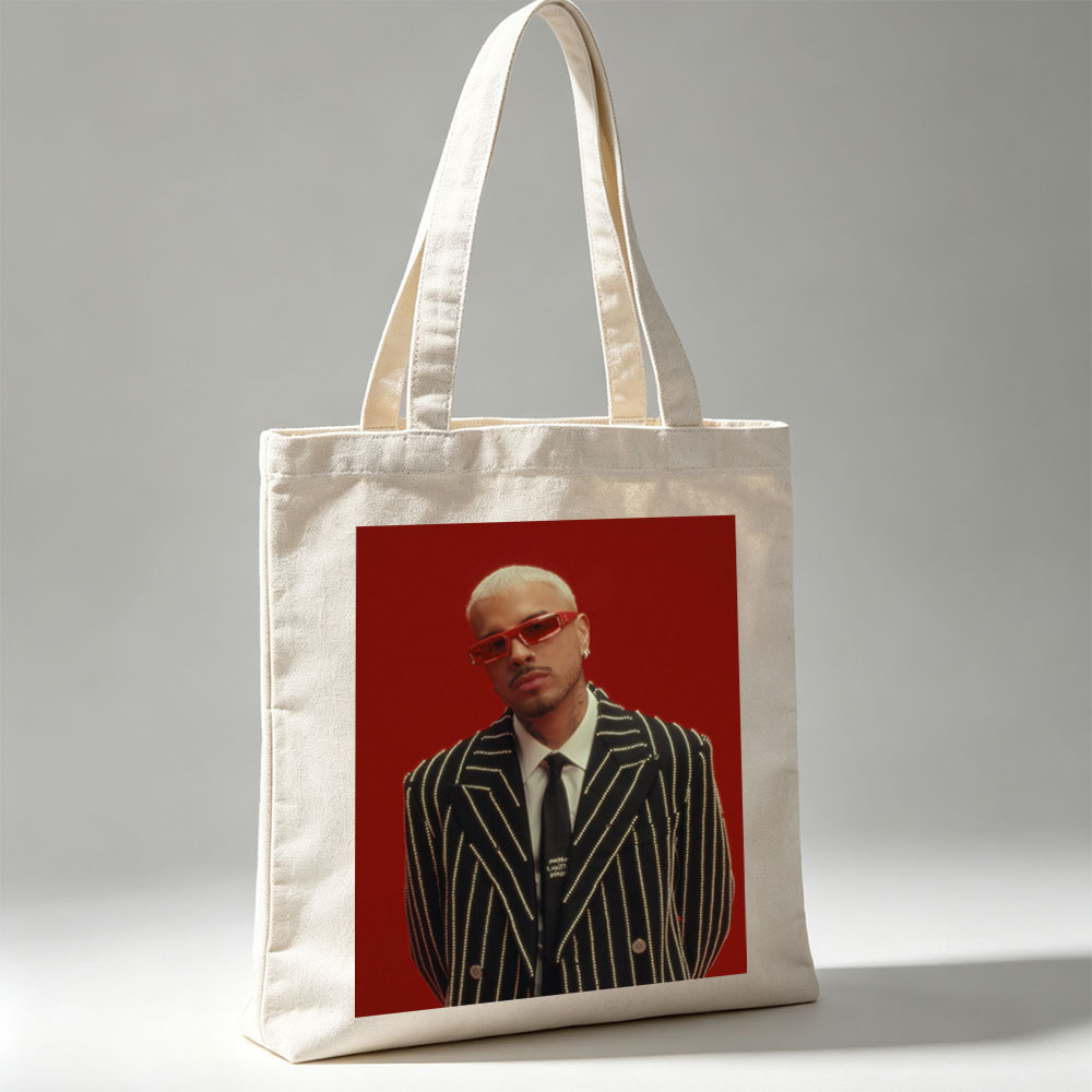 J Balvin in a Striking Red-Background Portrait Wearing a Glittering Black Suit and Red Sunglasses - Canvas tote bags