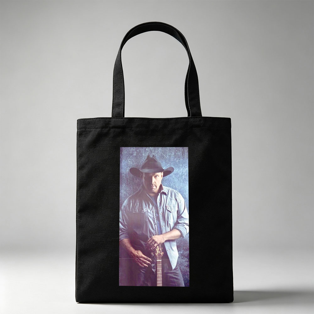 Garth Brook in Cowboy Hat Holding Guitar Against Textured Background - Canvas tote bags
