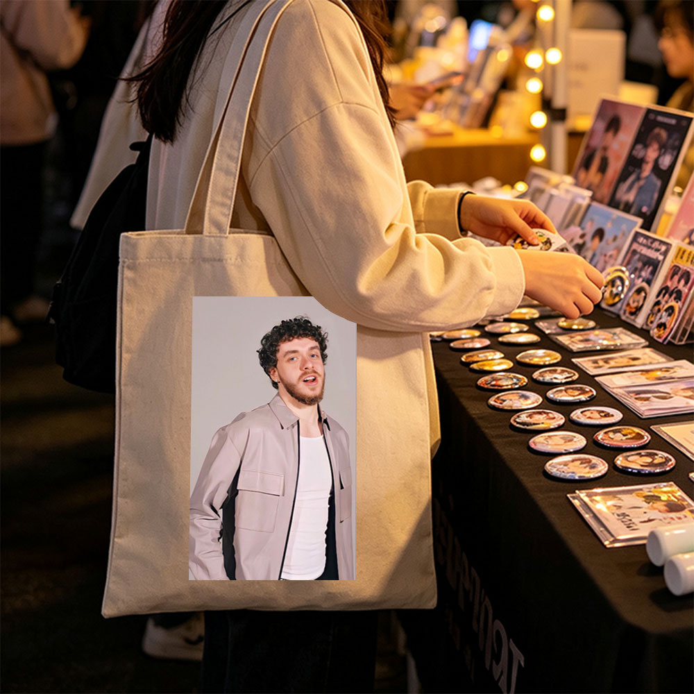 Jack Harlow in a Stylish Pose Wearing a Beige Jacket Over a White Shirt Against a Neutral Background - Canvas tote bags