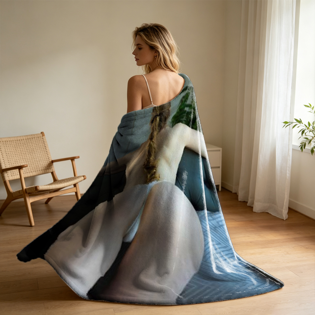 A young woman in a brown crop top and matching lounge pants sits barefoot in a teal armchair. - Blanket
