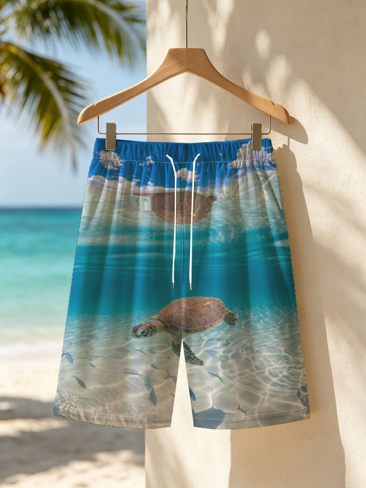 Sea turtle swims gracefully in clear blue water with fish below, sunlight filtering through the surface. -  Beach shorts
