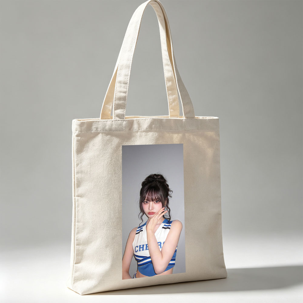 K-pop Idol in Cheerleader Outfit Poses with Hand on Face Against Gray Background - Canvas tote bags