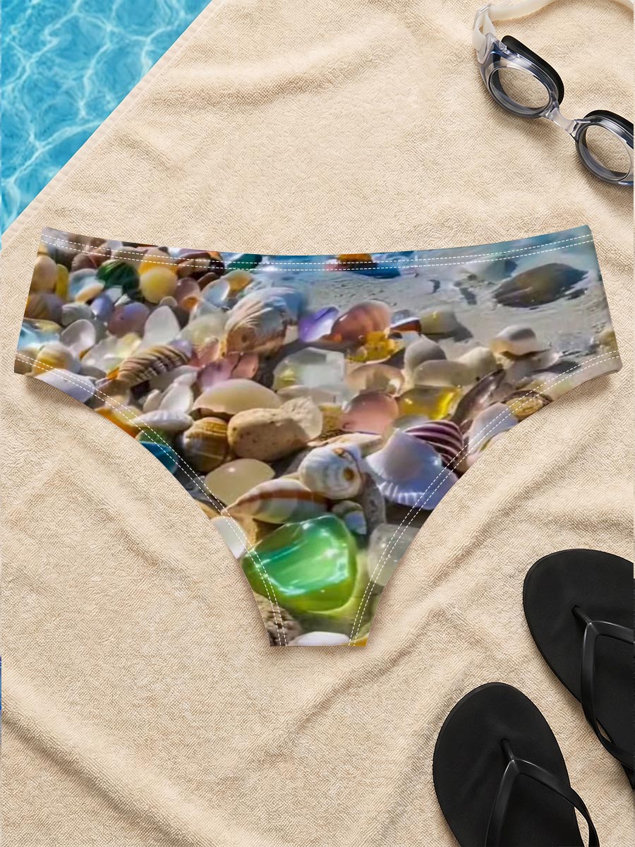 Colorful seashells on a tropical beach with clear blue water and sky. -  Men's swim trunks