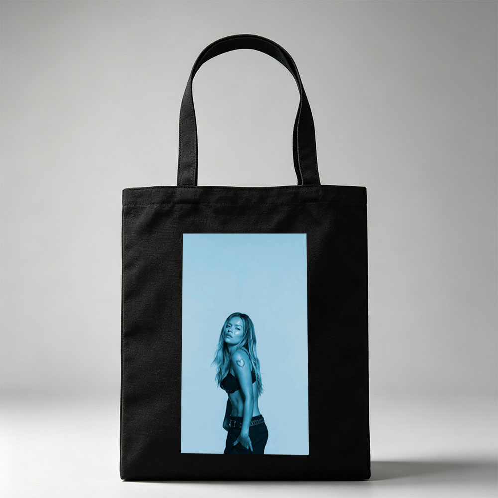 Khloe Kardashian in a Bold Pose with Heart Tattoo and Edgy Fashion Against a Cool Blue Backdrop - Canvas tote bags