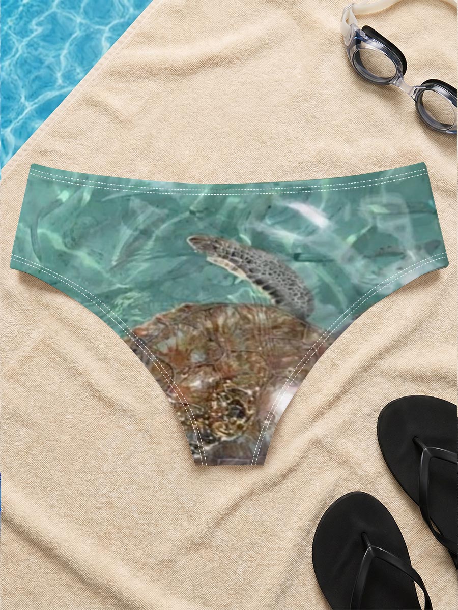 Sea turtle swims gracefully in clear turquoise waters at Playa Grandi. -  Men's swim trunks