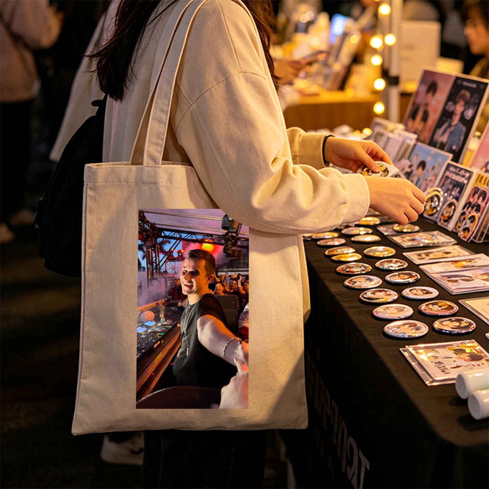 Martin Garrix at a Live DJ Set Performing for an Energetic Crowd Under Colorful Stage Lights - Canvas tote bags
