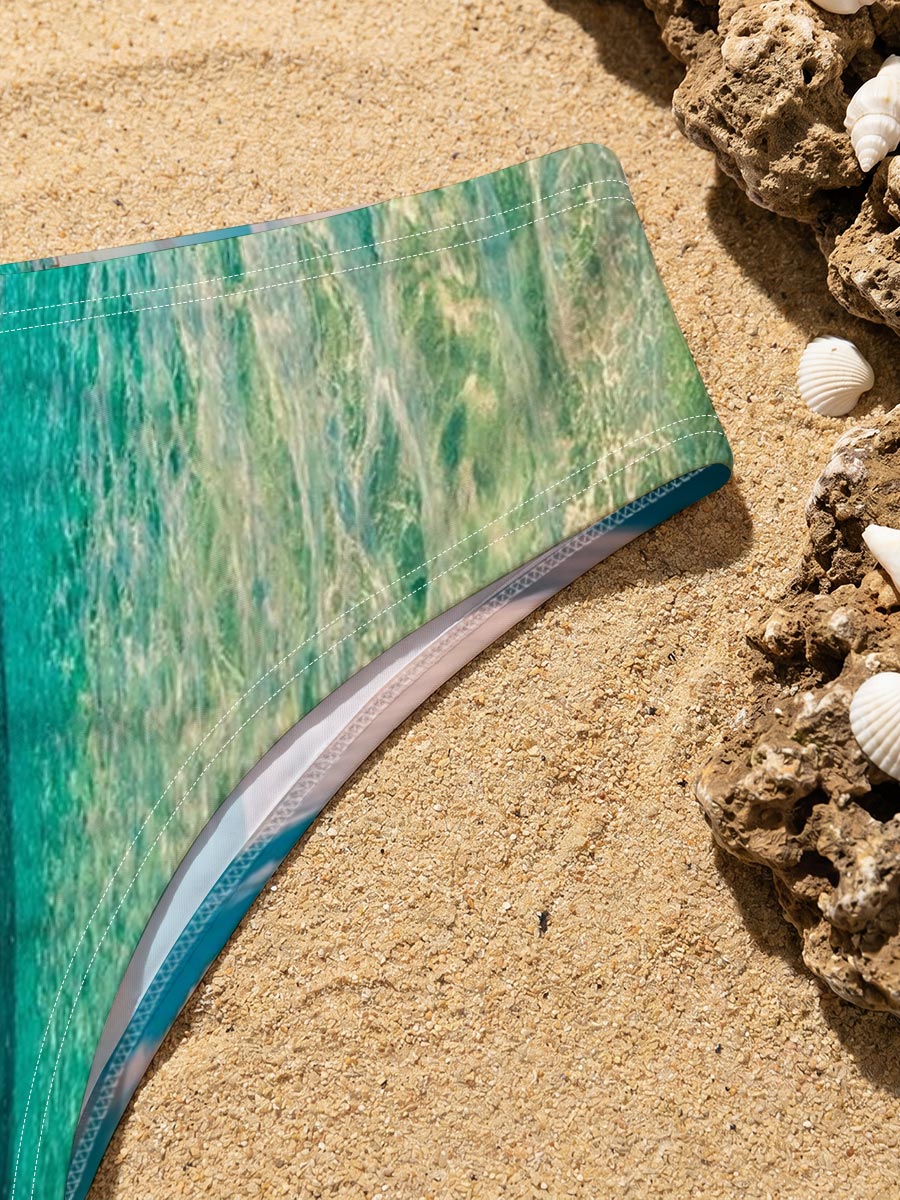 Overwater bungalows stretch into turquoise waters under a vibrant sky. -  Men's swim trunks