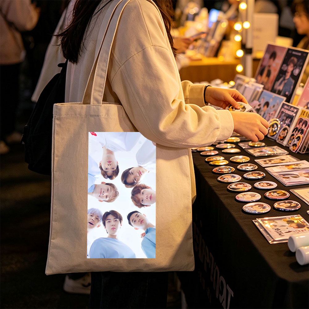 NCT Dream Members in a Circular Formation Wearing Light Blue Outfits Against a Bright Sky Background - Canvas tote bags