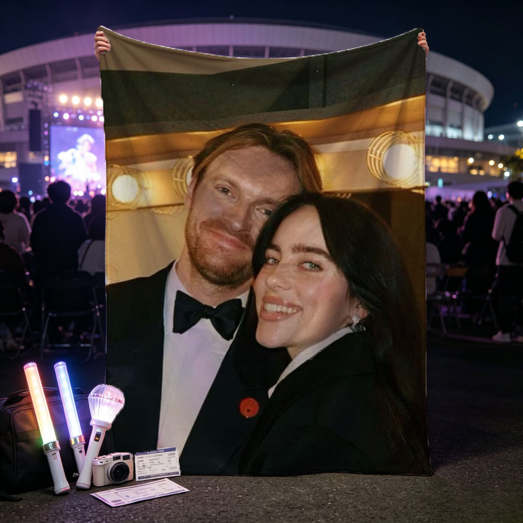 Lily Collins and Sam Claflin at a glamorous event, smiling together in formal attire with warm lighting in the background. - Blankets