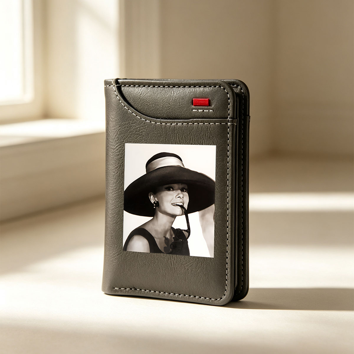 Audrey Hepburn in a wide-brimmed hat and sunglasses, exuding elegance and charm. - Vertical Style Wallet