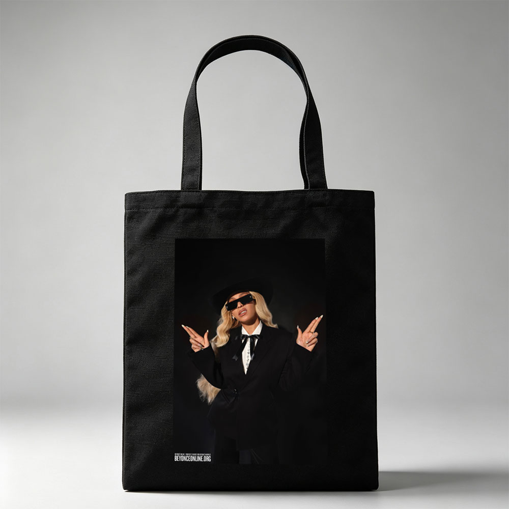 Beyonce in a Bold Black Suit and Hat Making Peace Signs Against a Dark Background - Canvas tote bags