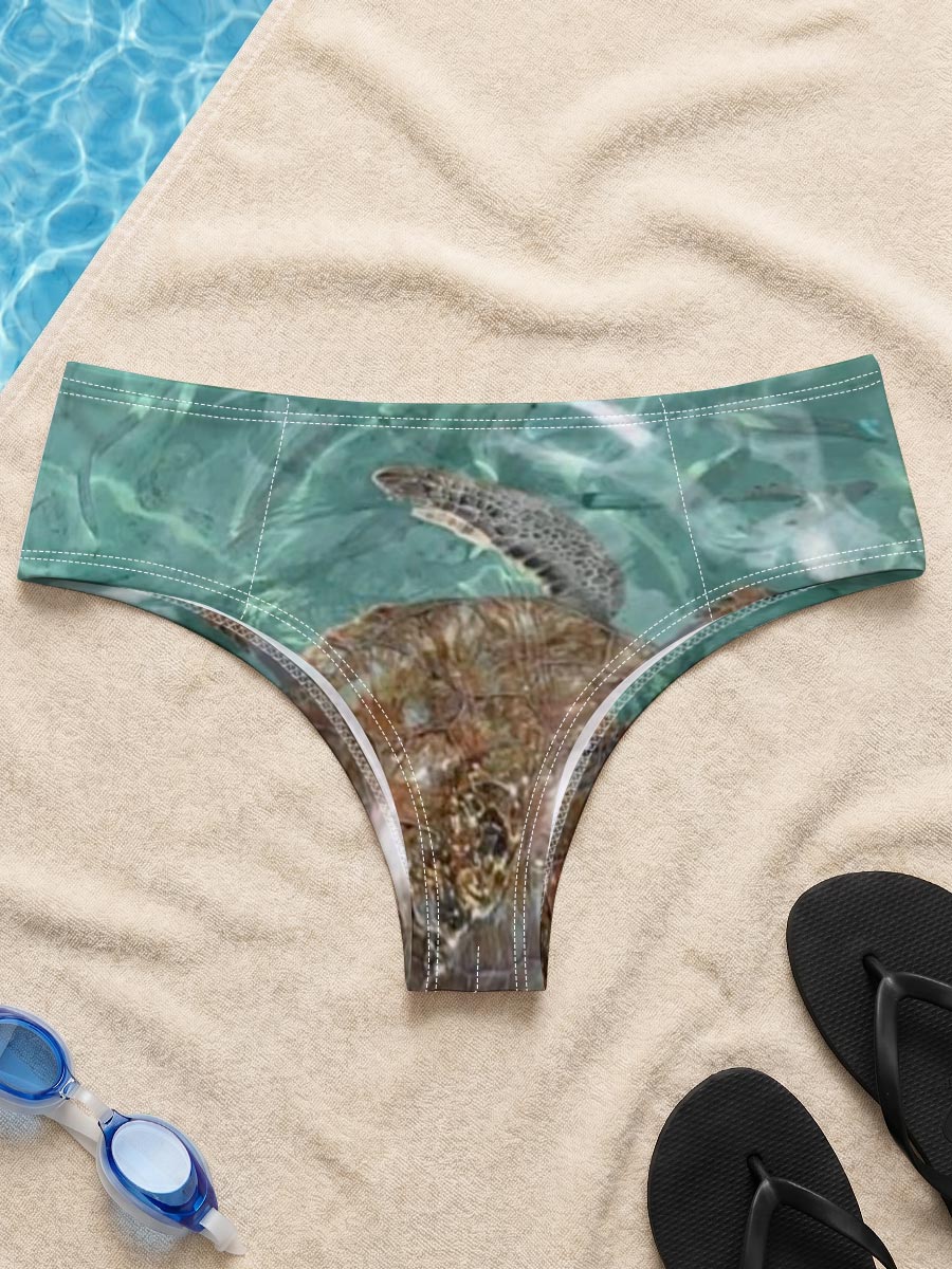 Sea turtle swims gracefully in clear turquoise waters at Playa Grandi. -  Men's swim trunks
