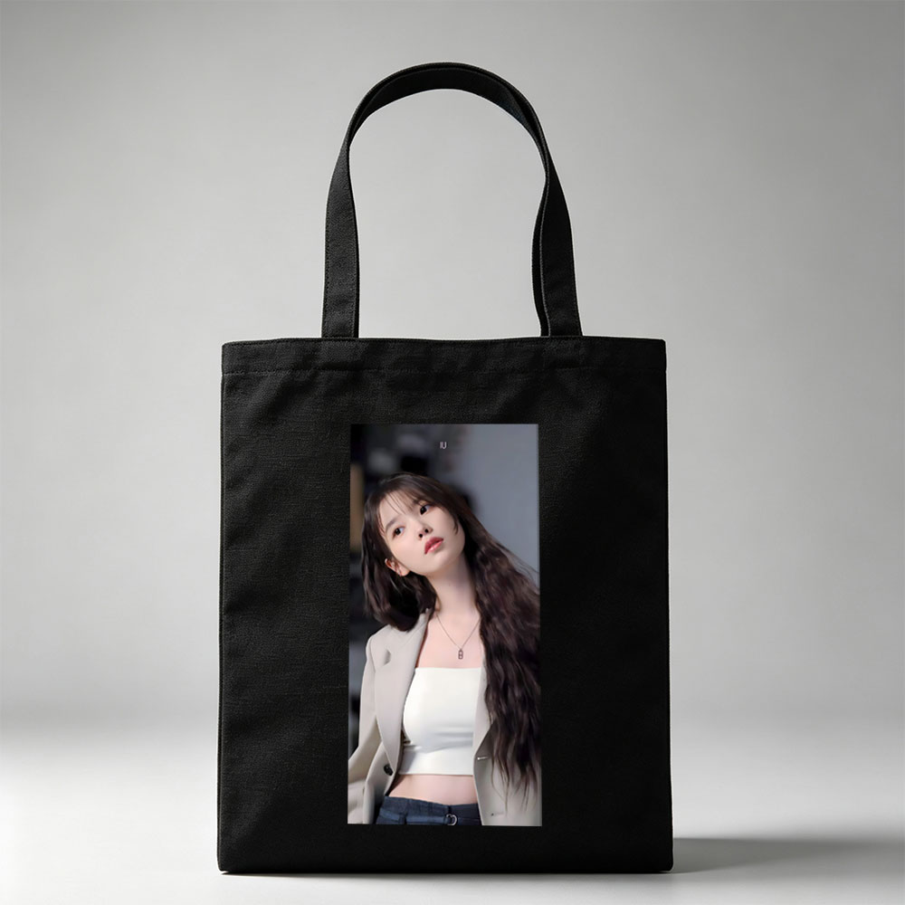 IU in a stylish outfit with a beige blazer and white crop top, showcasing her long wavy hair and elegant necklace. - Canvas tote bags