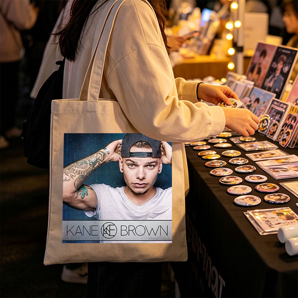 Kane Brown in a Casual Pose with Tattooed Arm and Cap on Dark Background - Canvas tote bags