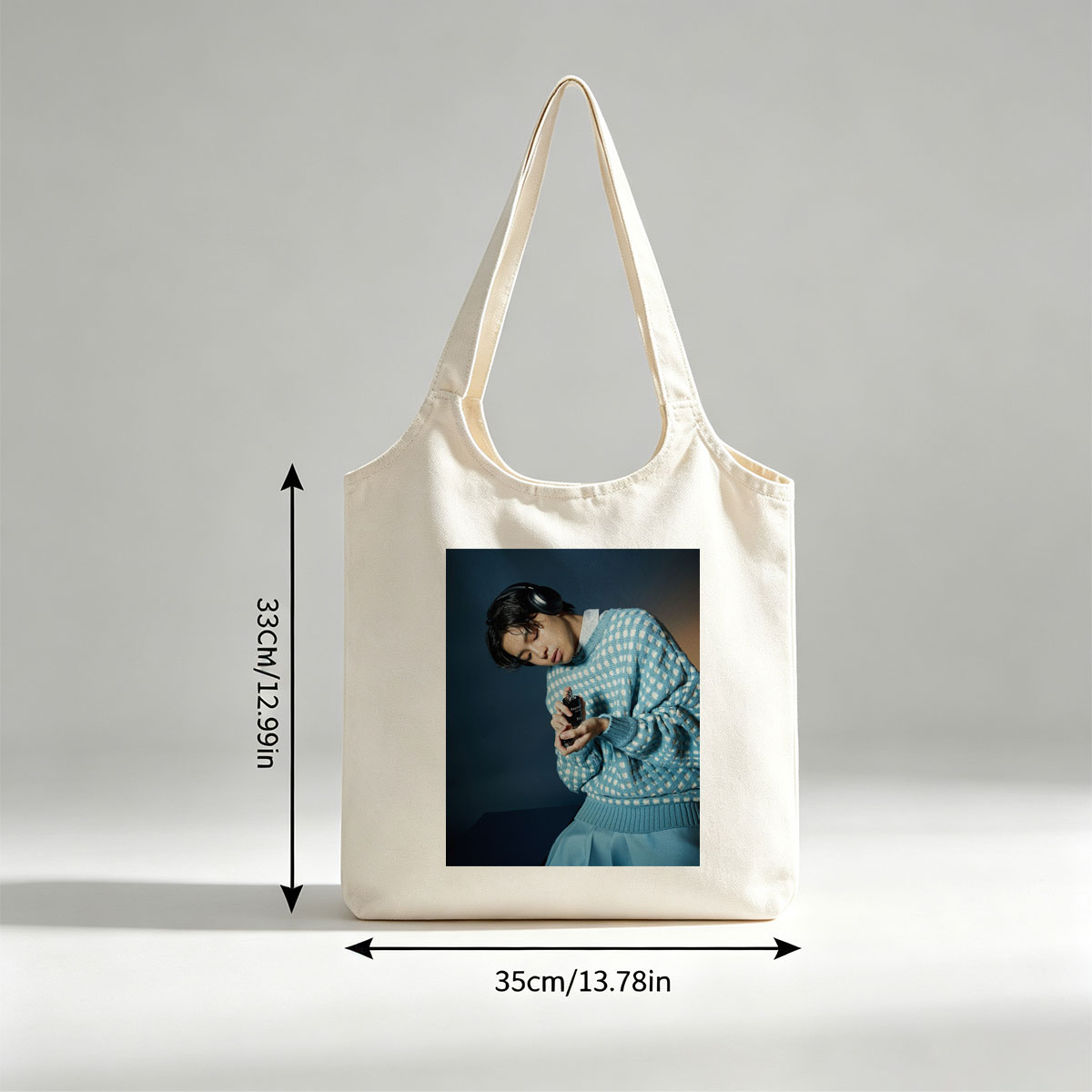 Jaden Smith in a Stylish Blue Sweater Holding a Perfume Bottle with Headphones On - Canvas shoulder bags/