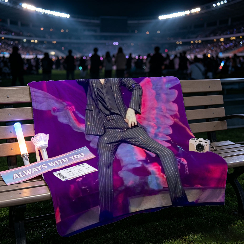 Adam Lambert on Stage in a Striped Suit with Dramatic Wing Props Under Purple Lighting - Blankets
