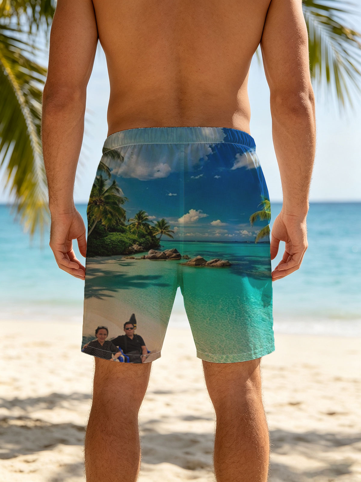 Couple relaxing on a tropical beach with turquoise waters and palm trees -  Beach shorts