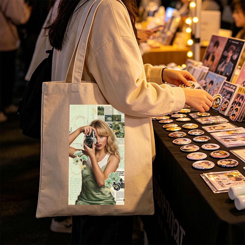 Margot Robbie Holding a Vintage Camera in a Collage-Style Portrait with Floral Elements and Photography Text Background - Canvas tote bags