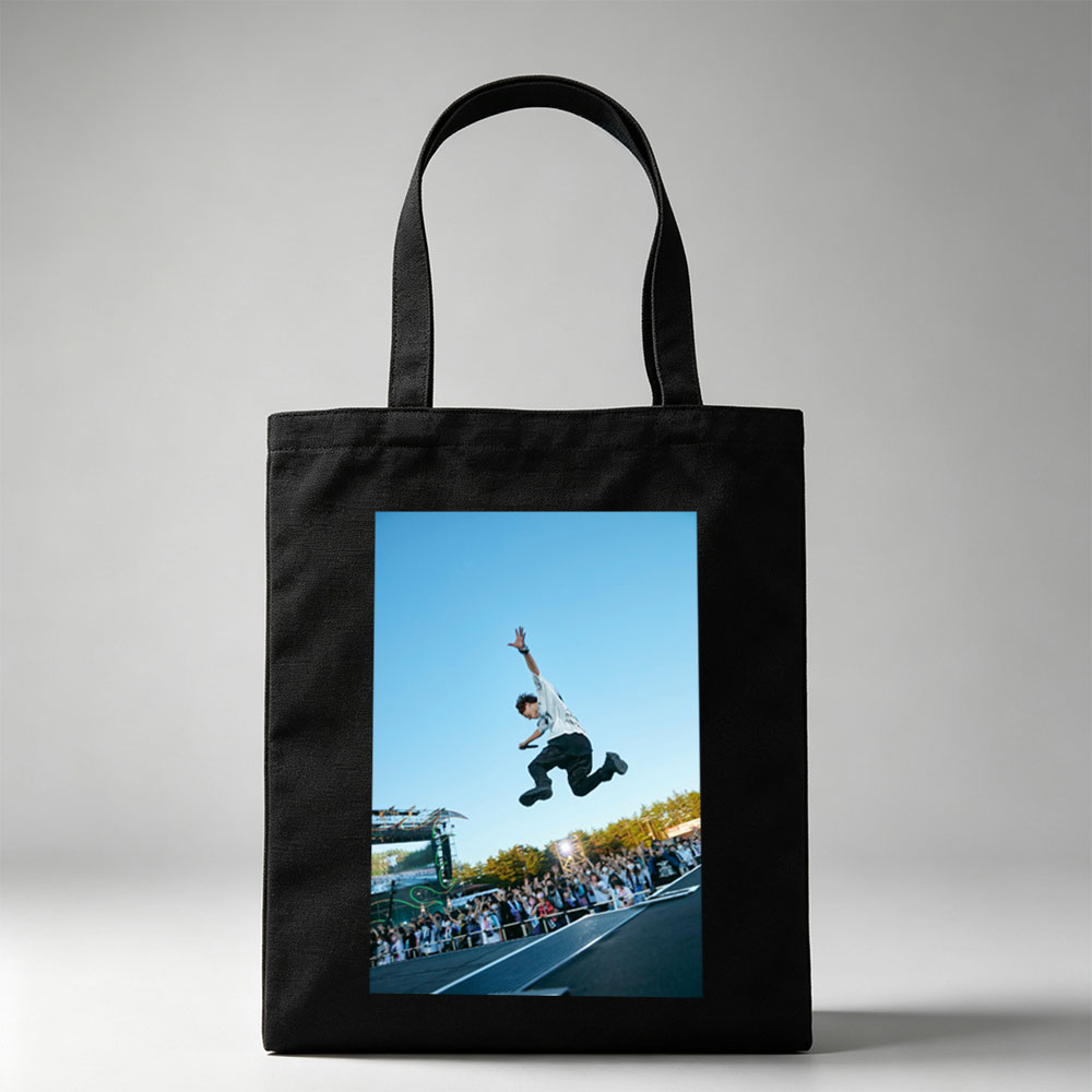 Skateboarder in Mid-Air Trick at Outdoor Festival with Crowd Watching - Canvas tote bags