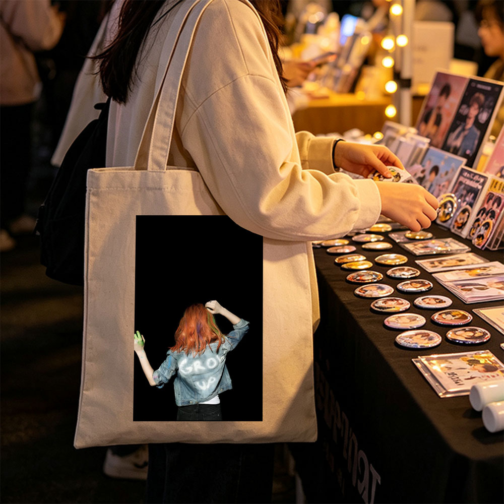 BTS Jungkook in a vibrant performance scene with colorful hair and denim jacket against a black background - Canvas tote bags