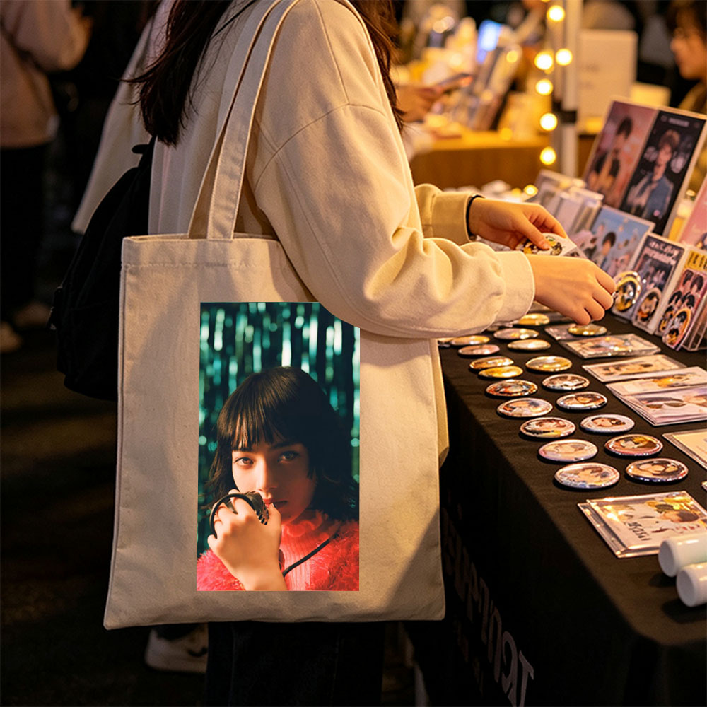 Smallville Actress Allison Mack in a Striking Red Outfit Holding a Microphone Against a Glittering Background - Canvas tote bags