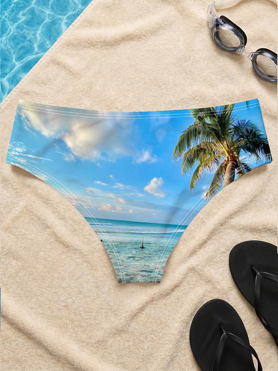 Tropical beach with palm tree leaning over clear blue water under a bright sky. -  Men's swim trunks