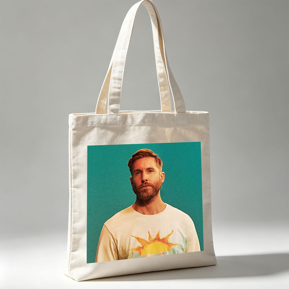 Calvin Harris in a Sun-Themed T-Shirt Against a Teal Background - Canvas tote bags