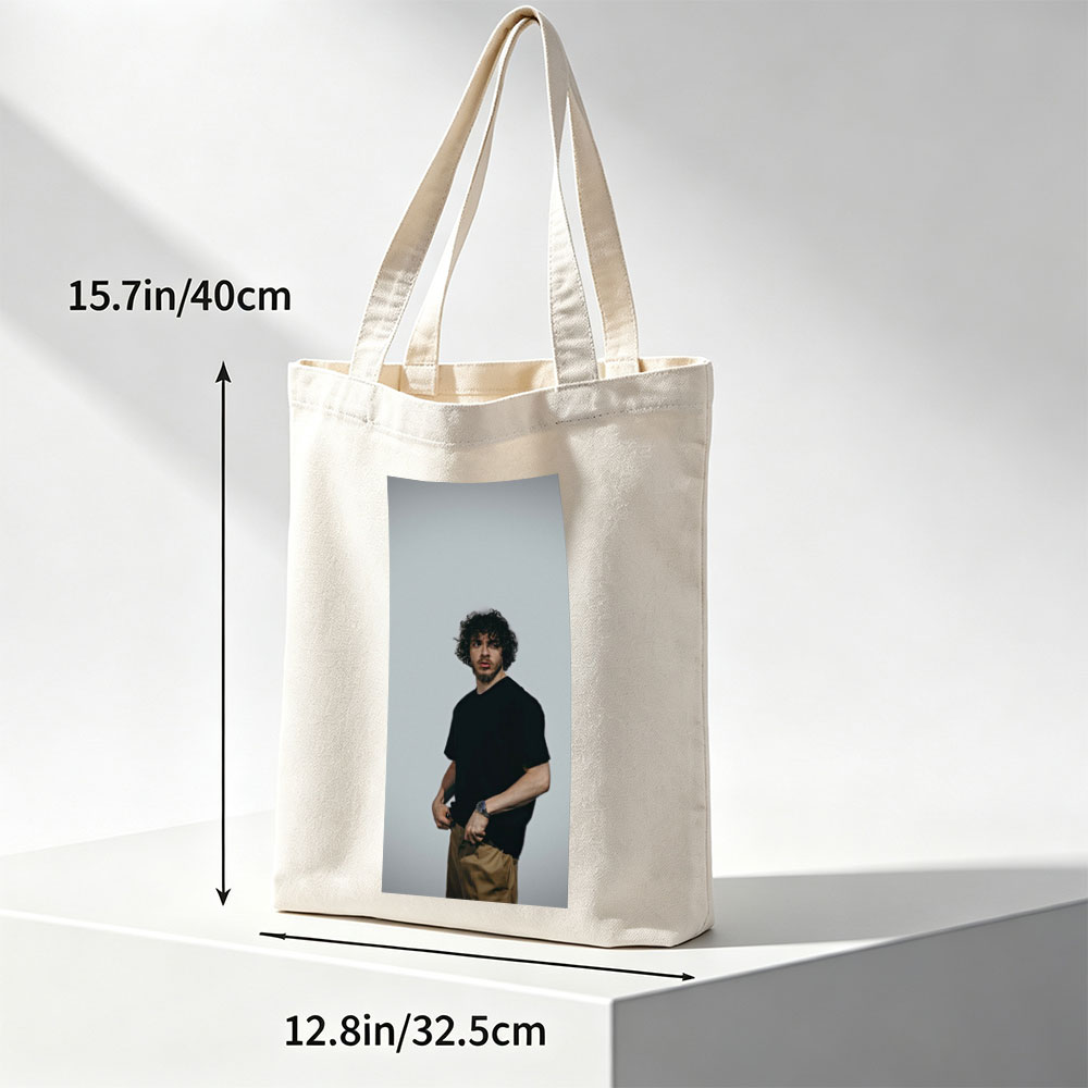 Jack Whitehall in a Casual Pose Wearing a Black T-Shirt and Beige Pants Against a Neutral Background - Canvas tote bags
