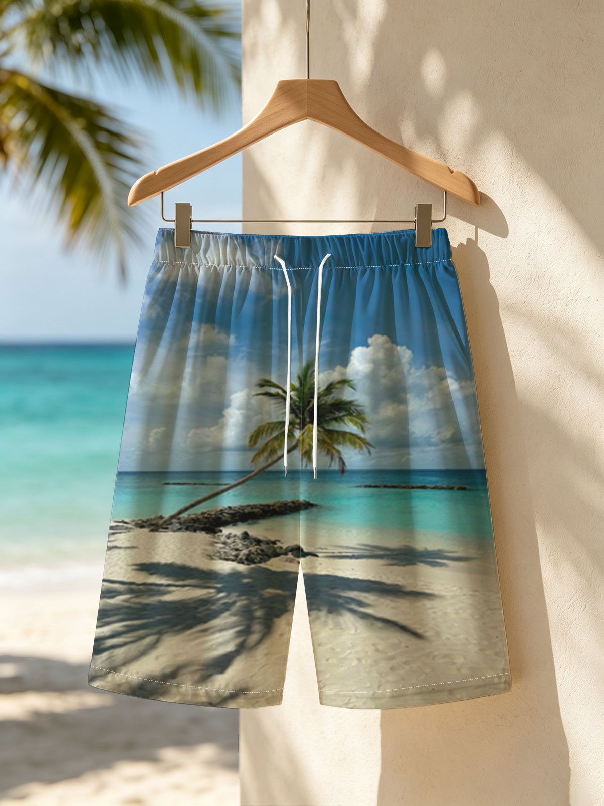 Tropical beach with palm tree leaning over turquoise water and white sand under blue sky. -  Beach shorts