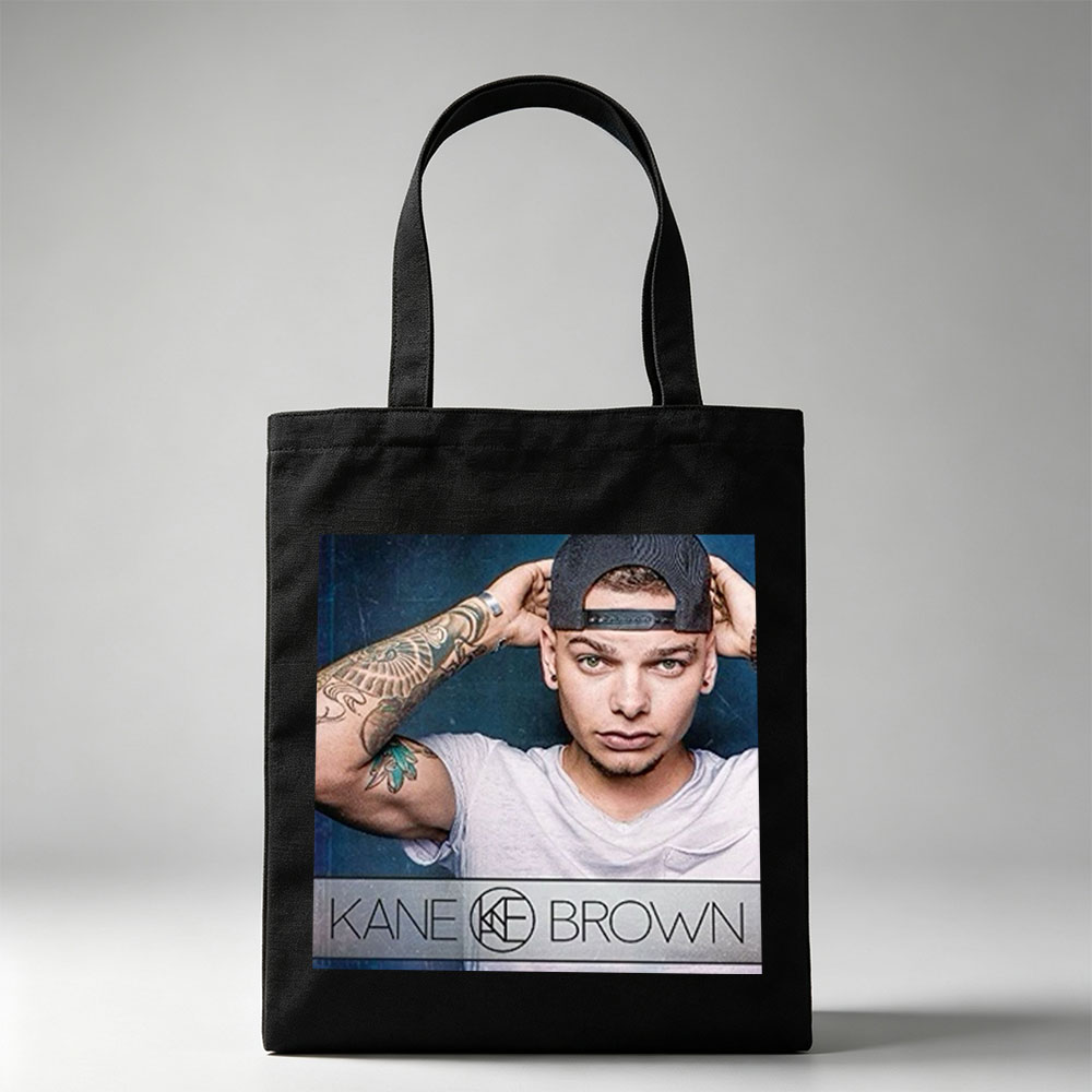 Kane Brown in a Casual Pose with Tattooed Arm and Cap on Dark Background - Canvas tote bags