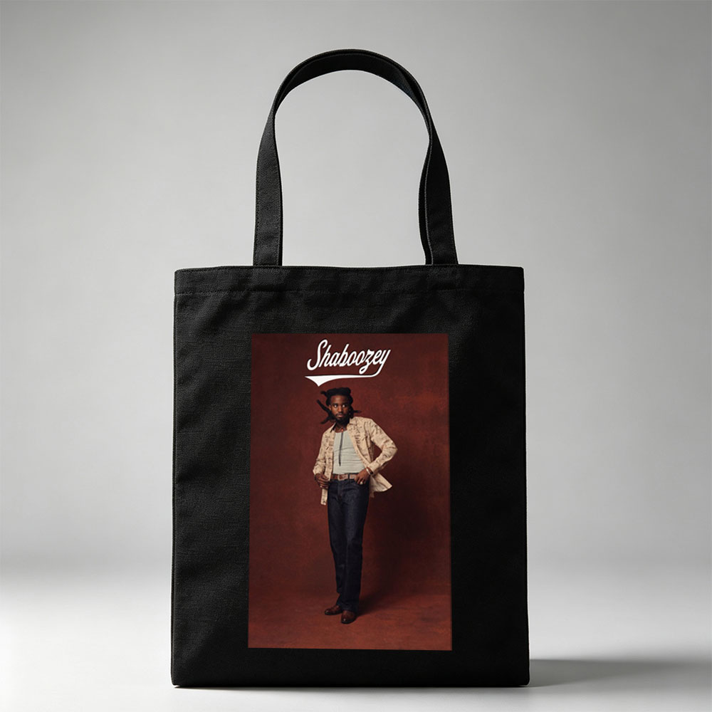 Shaboozey Standing Confidently in a Patterned Jacket and Jeans Against a Rich Red Background - Canvas tote bags