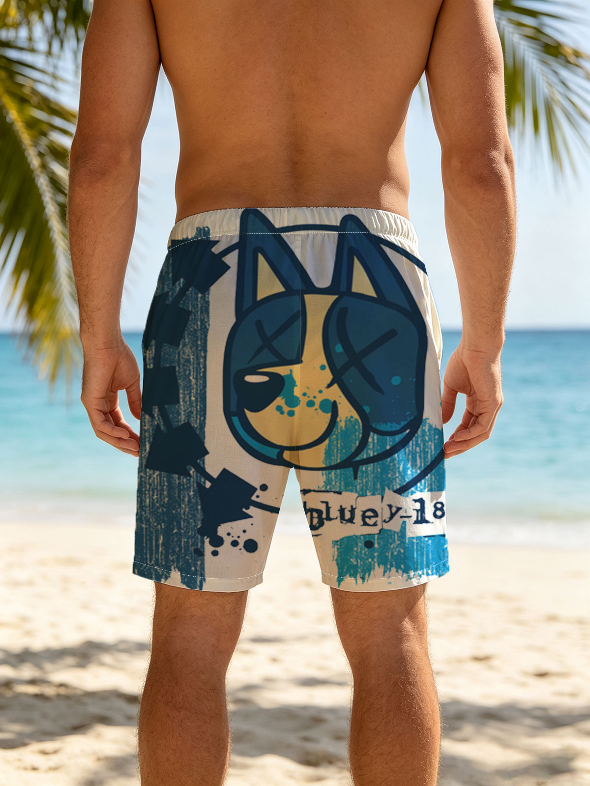 Bluey-182: A stylized blue and yellow cat face with X eyes, arrows, and splatter effects on a textured blue background. -  Beach shorts