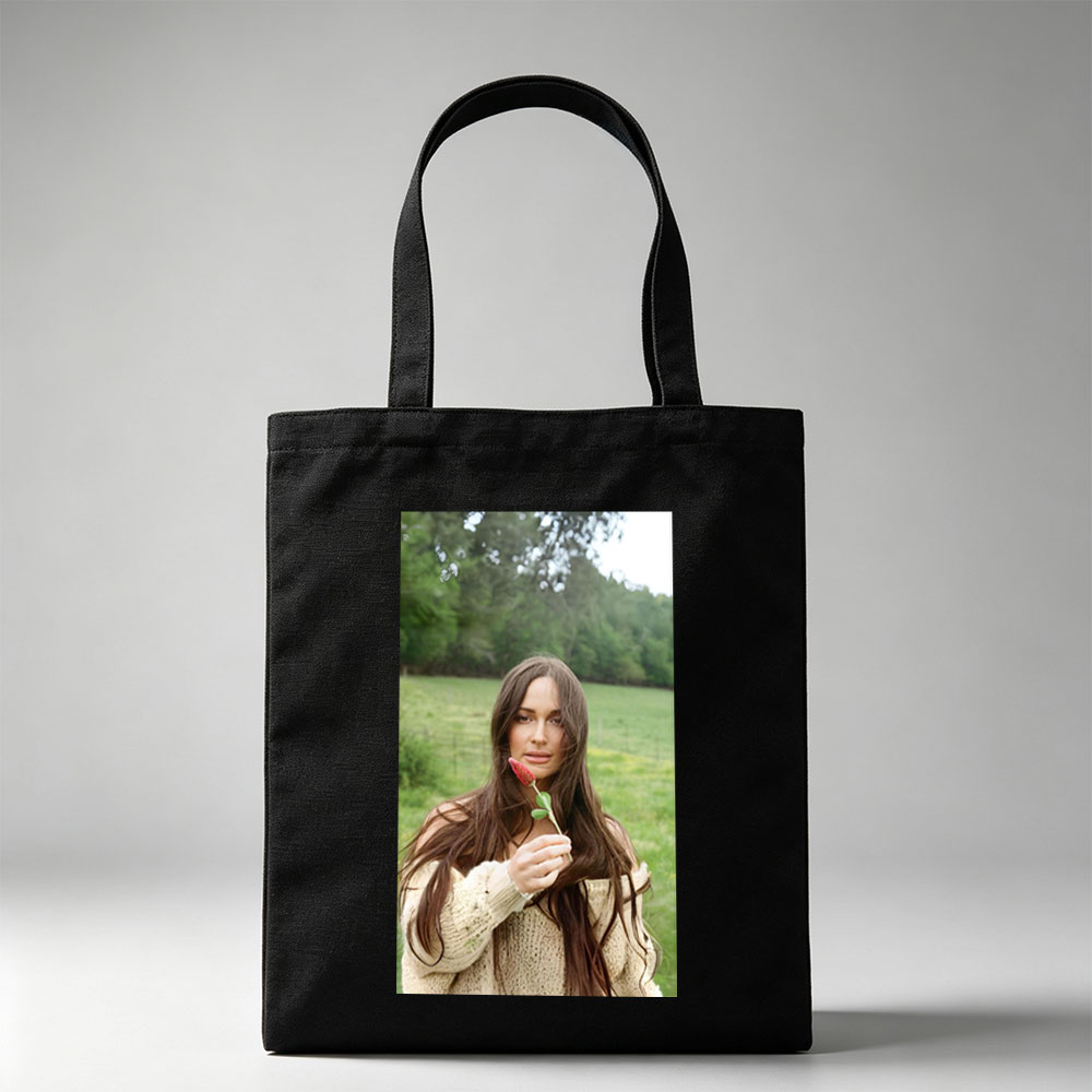 Lily-Rose Depp in a Serene Field Holding a Red Flower - Canvas tote bags