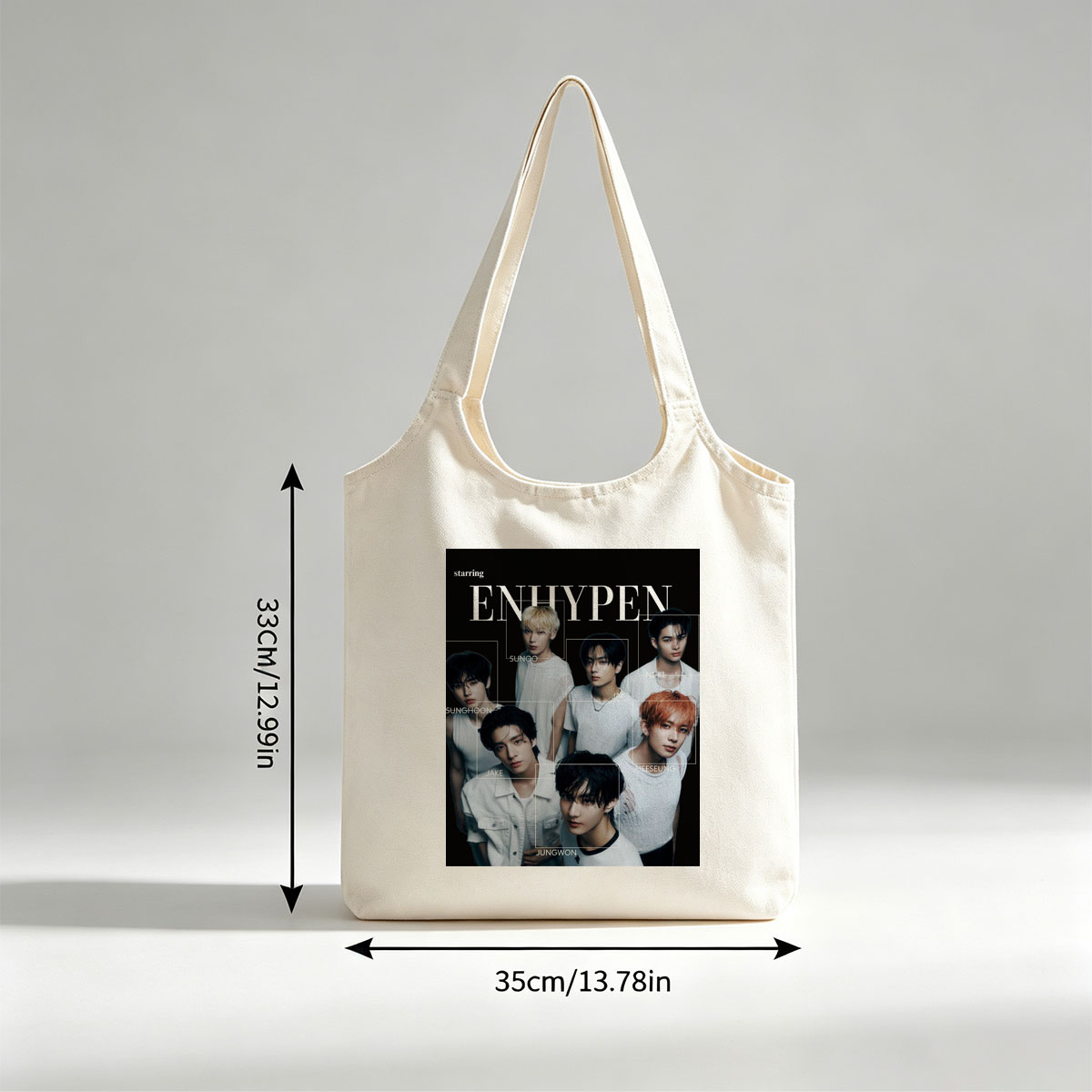 ENHYPEN in a striking black-and-white group portrait featuring all members in minimalist white outfits with individual name labels against a dark background - Canvas shoulder bags/