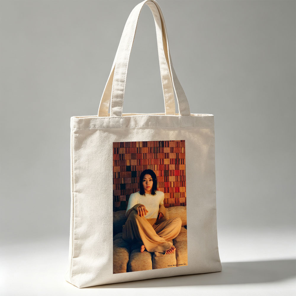 Ayaka Hirahara Sitting on Couch in Cozy Outfit Against Textured Wall Background - Canvas tote bags